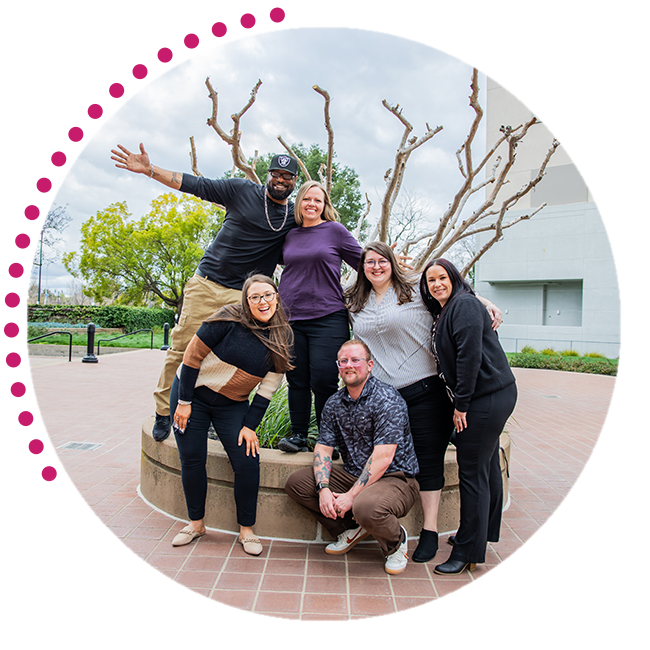 Group of people standing in front of a Chevron Federal Credit Union logo wall